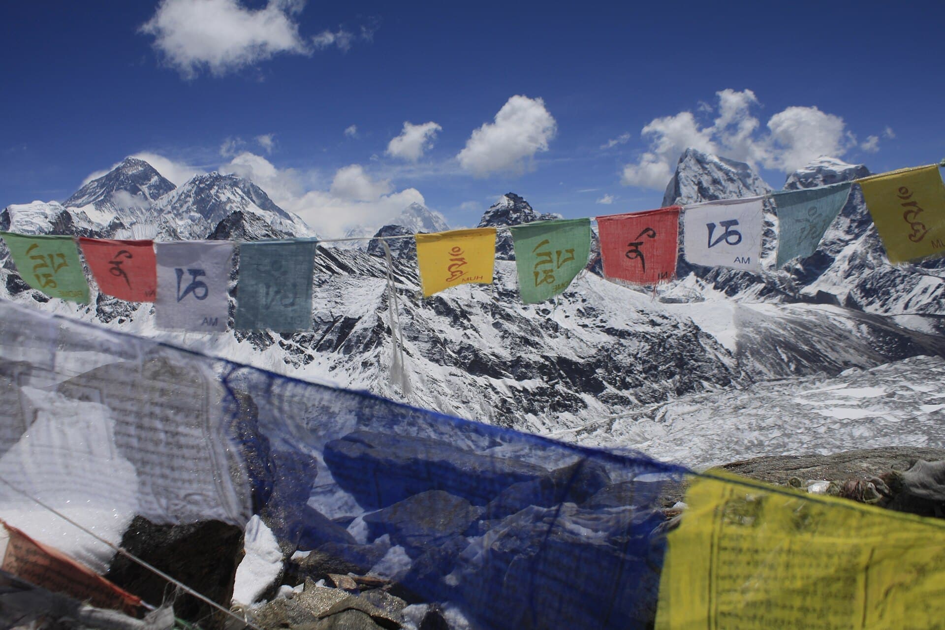 Prayer flags in front of snow-covered Himalayan peaks near Gokyo, Nepal