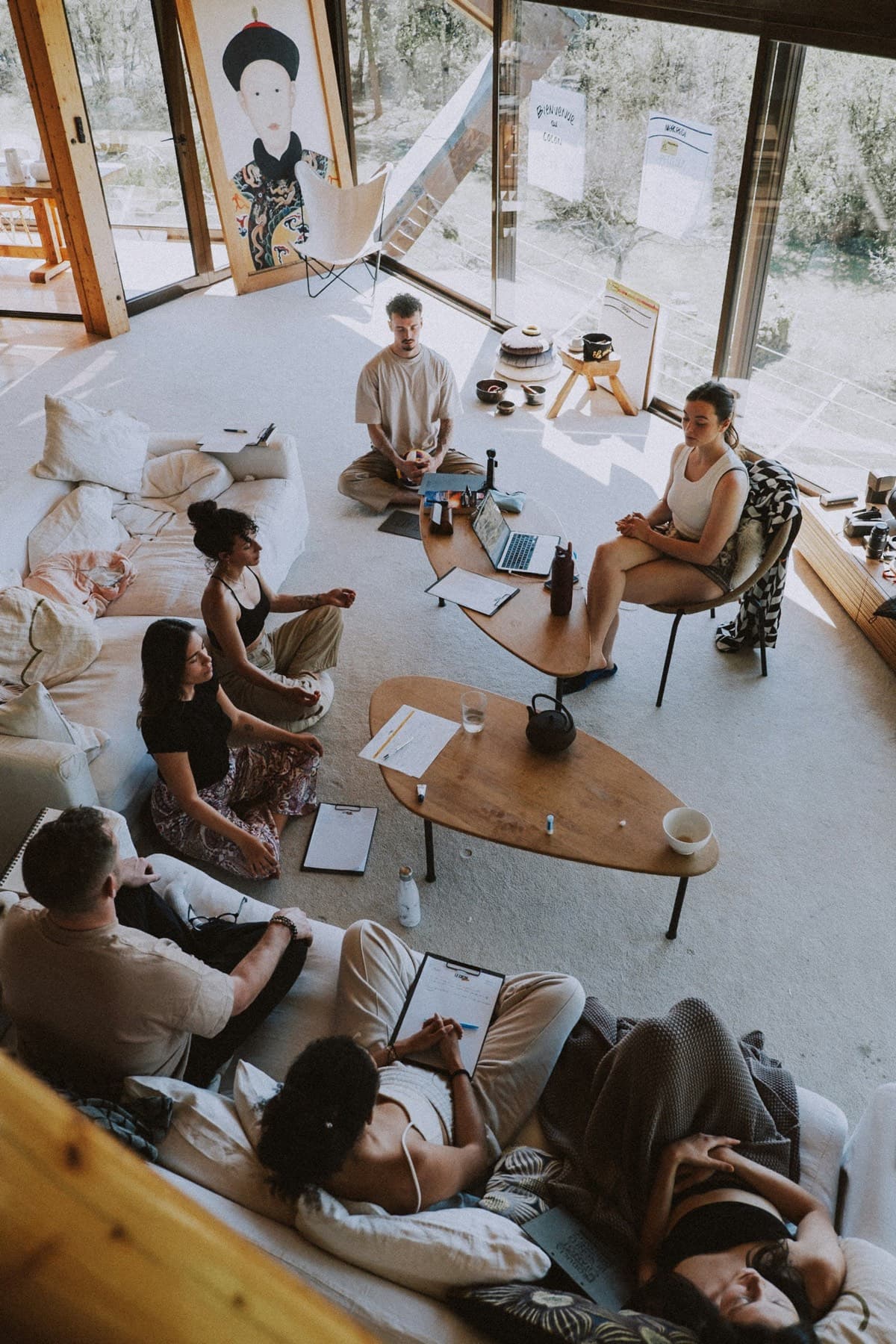 A small group seated together in a light-filled room during a workshop
